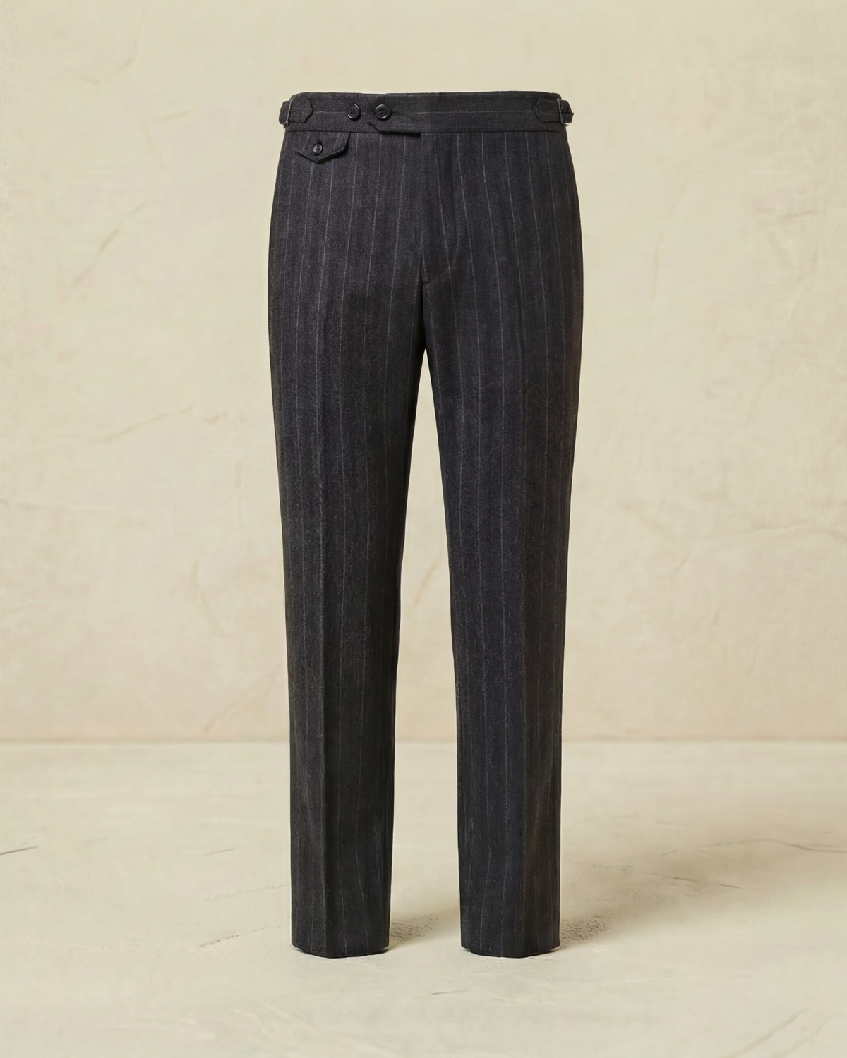 Dark pinstripe pants on a beige background
