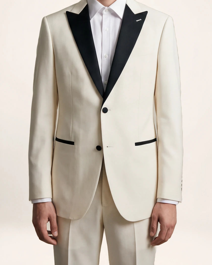The Ascension Suit — ivory suit with black trim, front view on a model