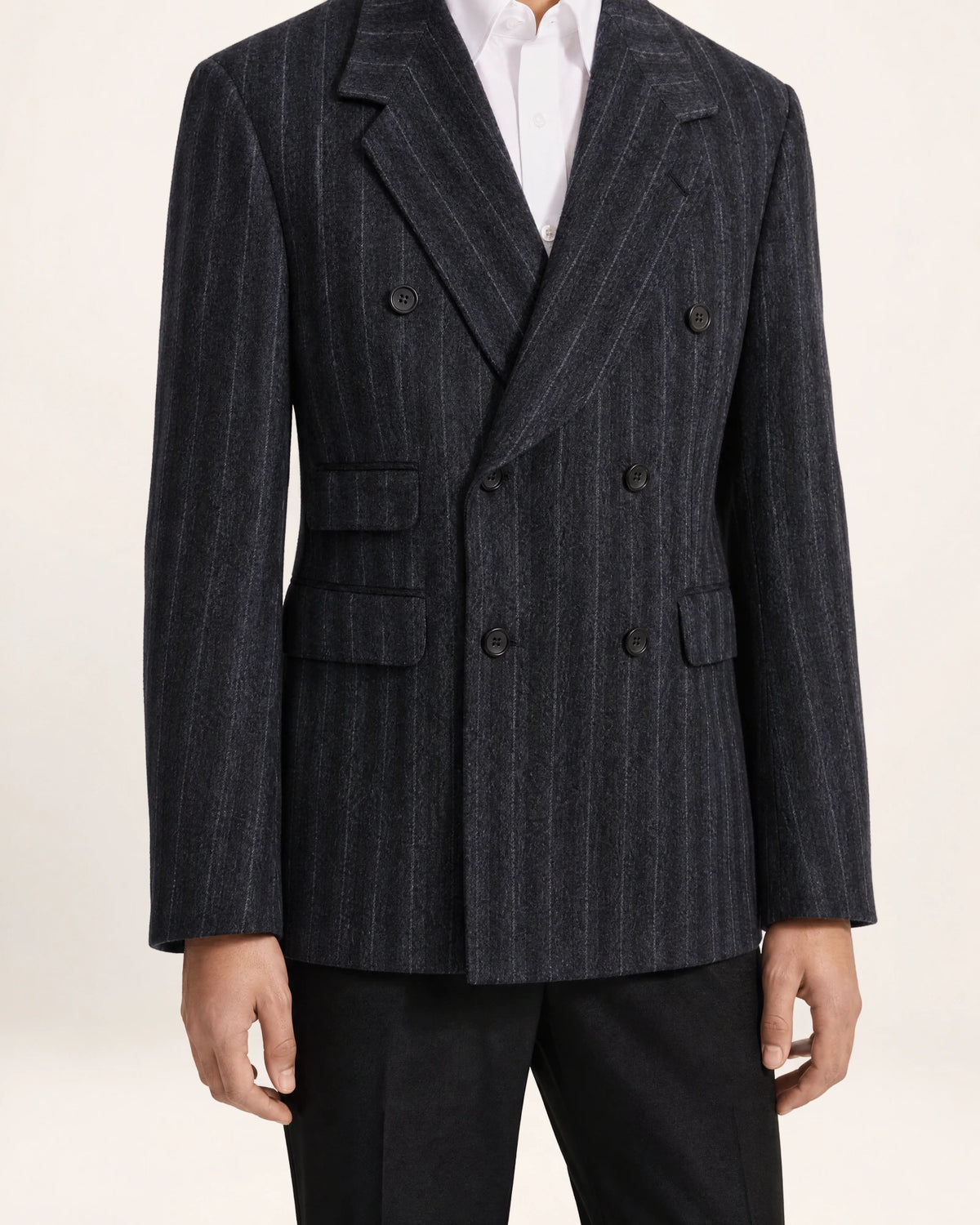 The Command Jacket — charcoal striped double-breasted jacket, front view on a model