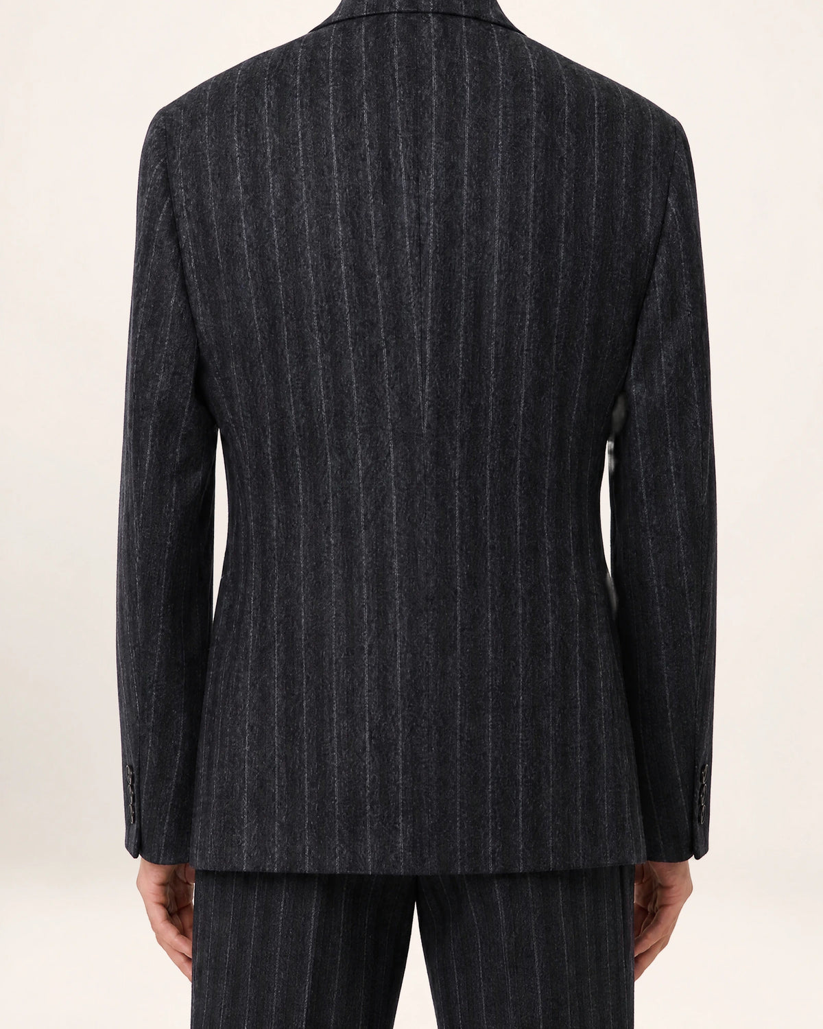 The Command Jacket — charcoal striped double-breasted jacket, back view on a model