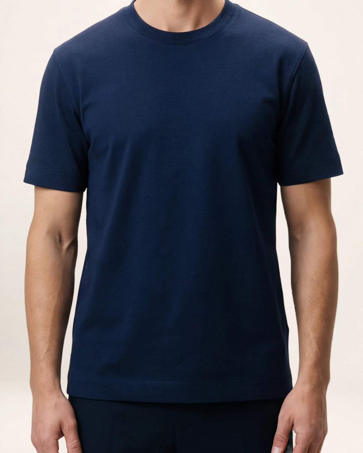 The Foundation Tee — navy T-shirt, front view on a model