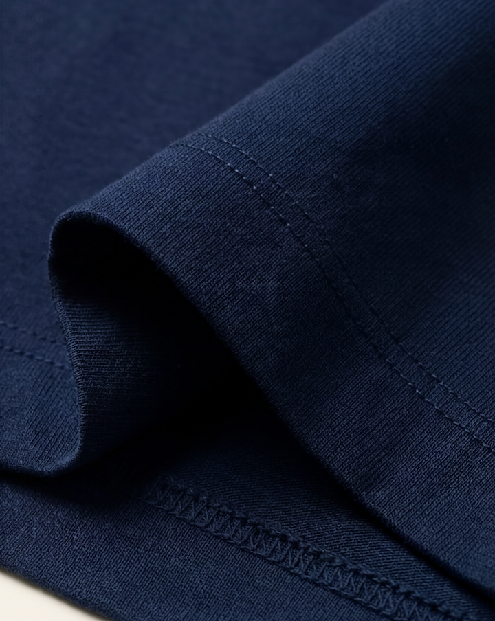 The Foundation Tee — navy T-shirt, sleeve hem and texture detail
