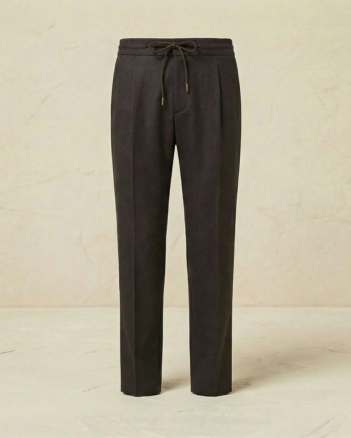 Dark gray pants on a light beige background
