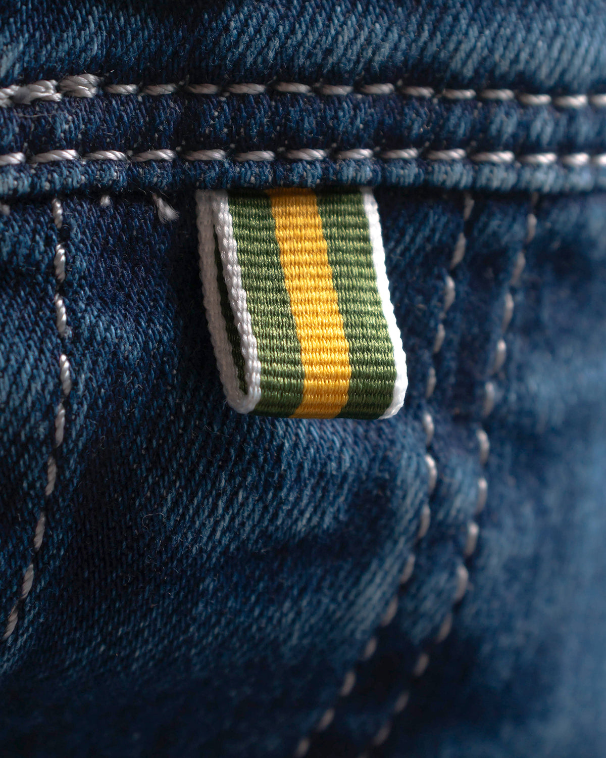 The Stretch Denim — denim, striped tab and seam detail