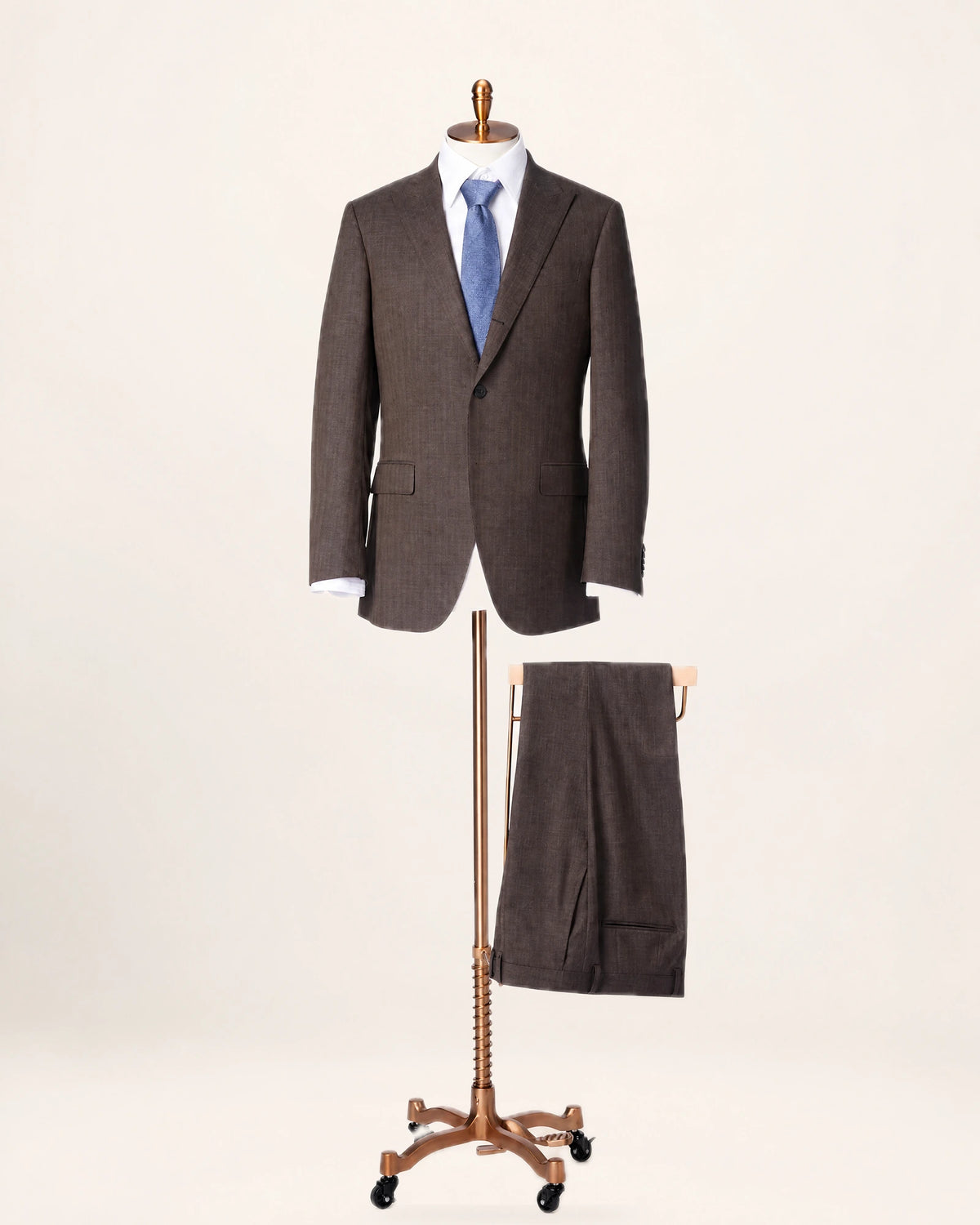 The Apex Suit — brown suit, jacket and trousers on a stand, front view
