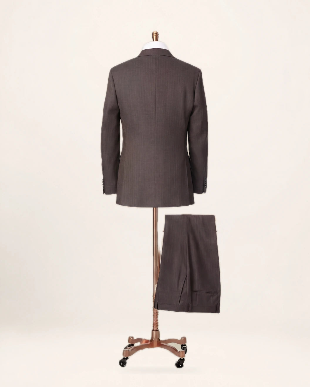 The Apex Suit — brown suit, jacket and trousers on a stand, back view