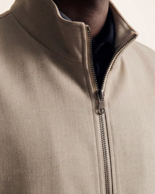 The Ascent Vest — grey-beige zip vest, standing collar and zip detail