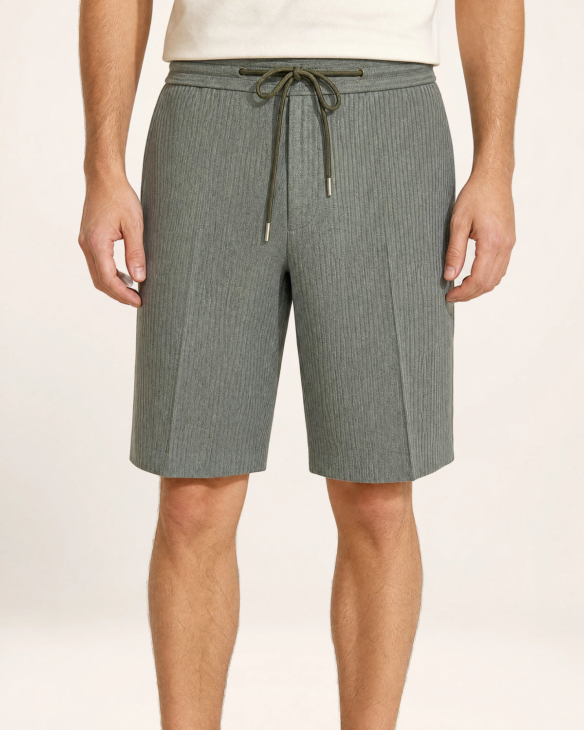 The Dune Short — grey-green shorts, front view on a model