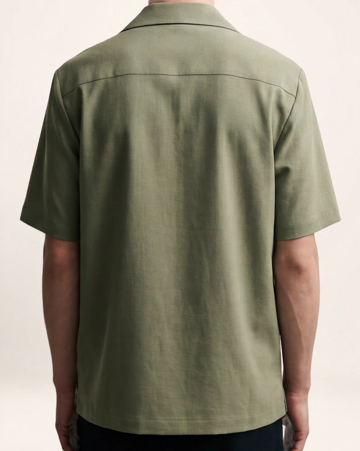 The Horizon Shirt — olive short-sleeve shirt, back view on a model