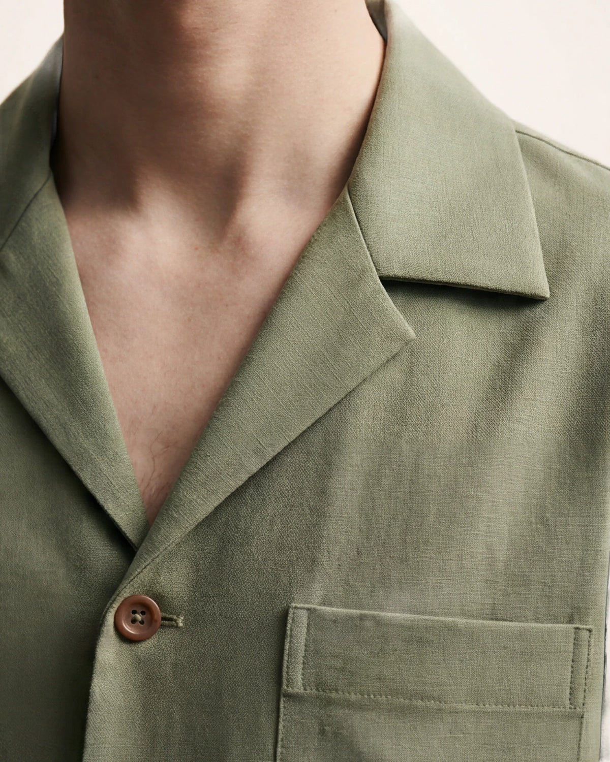 The Horizon Shirt — olive short-sleeve shirt, collar and chest pocket detail