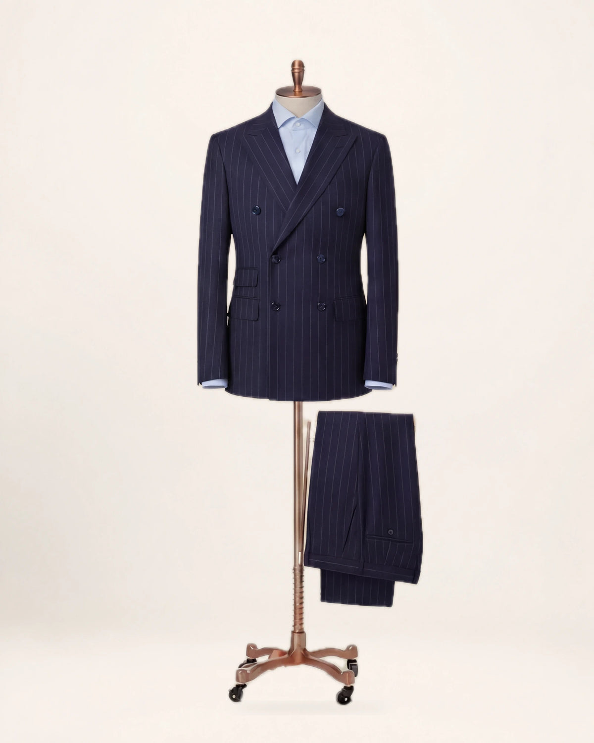 The Power Suit — navy pinstripe suit, jacket and trousers on a stand, front view