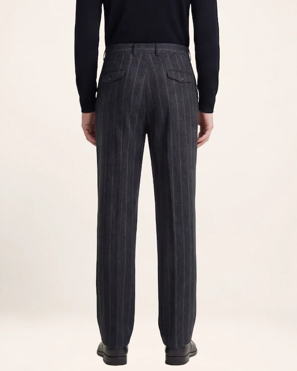 The Resolve Trouser — charcoal striped trousers, back view on a model
