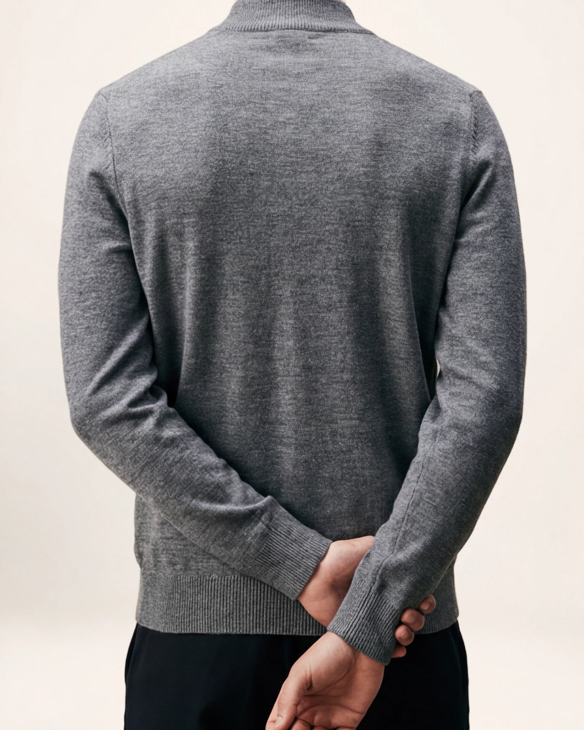 The Voyager Knit — grey crew-neck knit, back view on a model