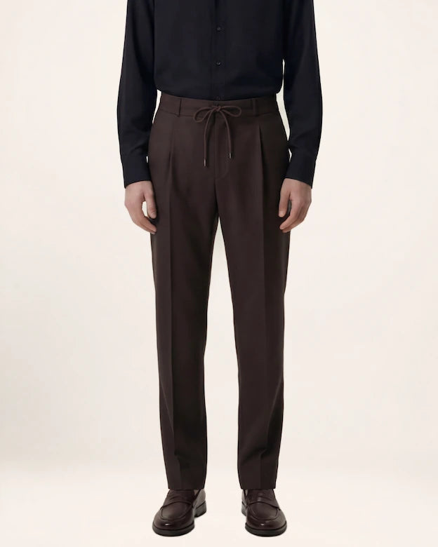 The Wayfarer Trouser — dark brown trousers, front view on a model